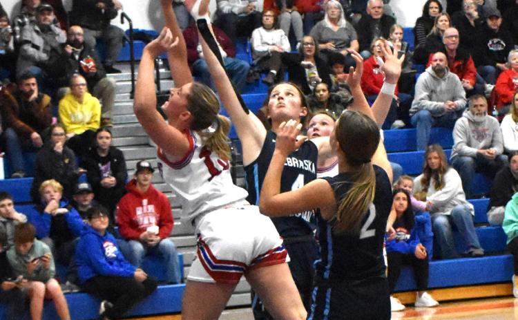 Courtney Carlstrom fights some Nebraska Christian girls for the rebound. PCN photo by Beth Sparrow.