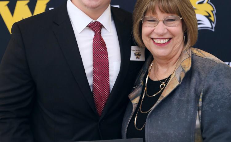 Braylon Peterson of Osceola (left) receives his certificate of scholarship from Wayne State College president Marysz Rames. Photo provided.