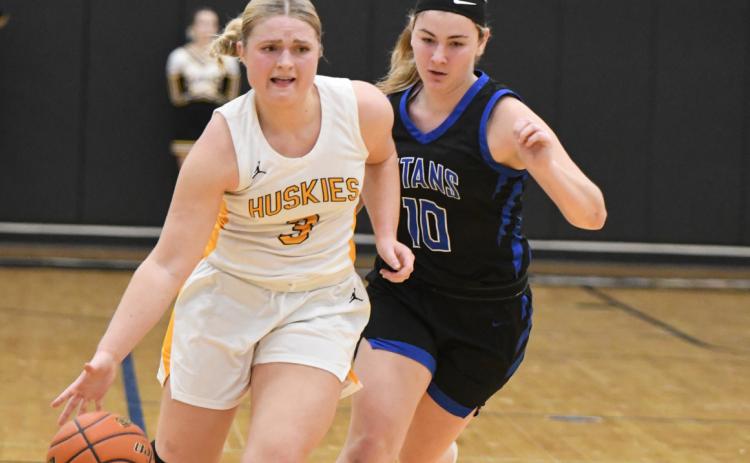 Ava Larmon drives the ball down the court with a Titan on her heels. PCN photo by Calvin Holtz