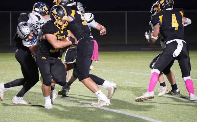 Senior Ethan Fjell takes the ball while Collin Vrbka and Isaac Whitmore defend E-M. PCN photo by Jen Vrbka.