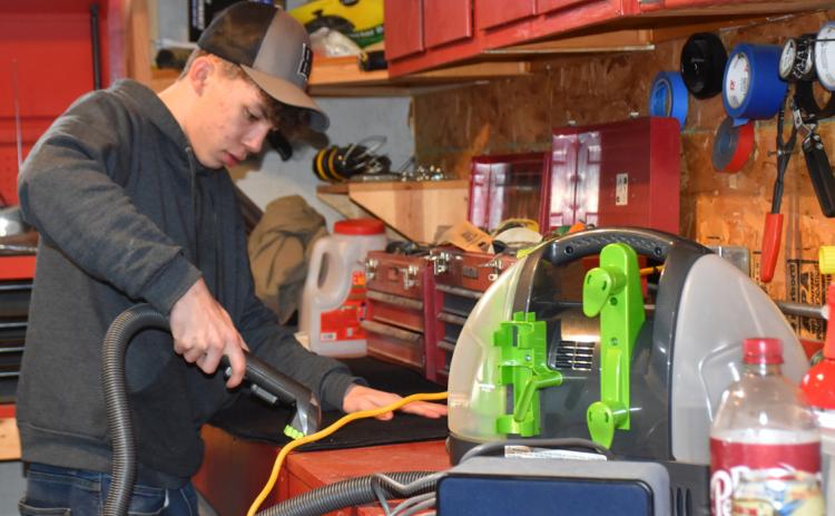 Tyler Shoup may be just a junior at Cross County, but at 17-years-old he started his own detailing business out of his parent's garage. PCN photo by Beth Sparrow
