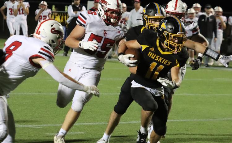 Shelby-RC junior running back Carter Eickmeier (11) scores on an eight-yard run late in the third quarter against Sandy Creek on Friday night. Eickmeier ran for three scores in the Huskies 32-24 win. PCN photo by Ken Kush.