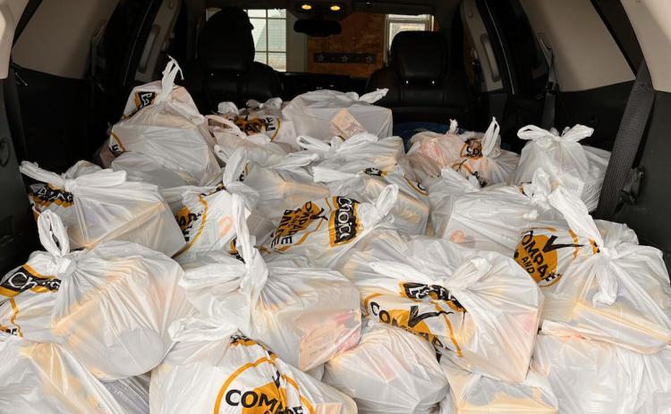 The back of this SUV is piled with sacks of food to be delivered to schools for the backpack program. Photo provided.