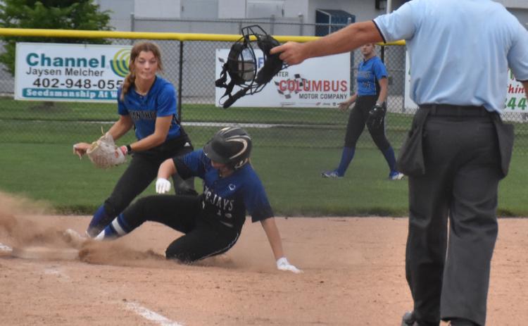 Nicole Martensen tags a GACC runner at third base as the referee makes the call. PCN photo by Beth Sparrow.