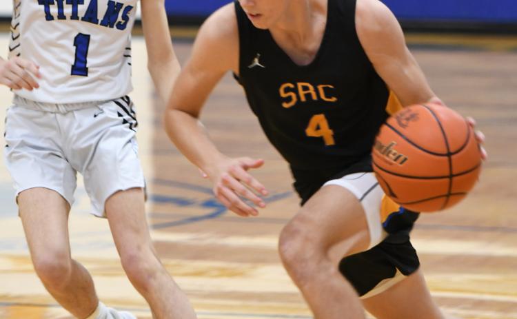 Isaac Whitmore drives past the Twin River defender on his way to the basket. PCN photo by Rick Holtz