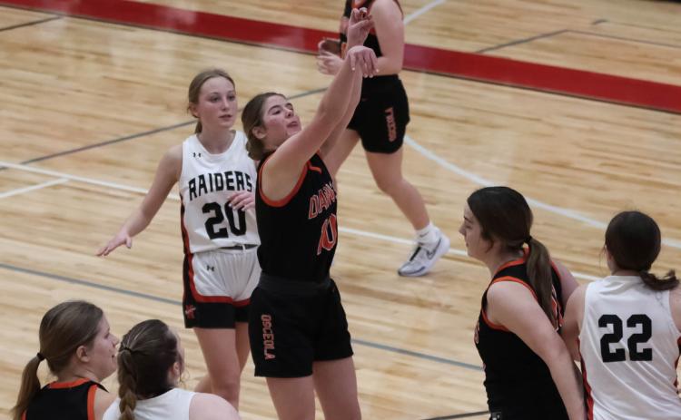 Addison Theis takes the shot against Mead while teammates Bella Recker and Melinn Roberts block. PCN photo by Blaine Winslow.