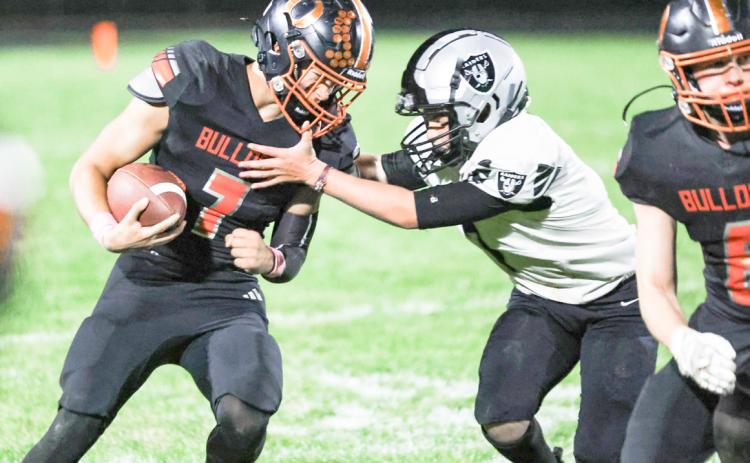 Osceola sophomore Milo Gehring tires to get around the defense of the Lawrence-Nelson defender in Friday night season finale in Osceola. PCN photo by Blaine Winslow.