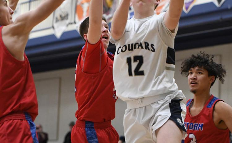 LEFT: Ashton Seim drives for two of his team-high 13 points of Cross County. PCN photos by Rick Holtz