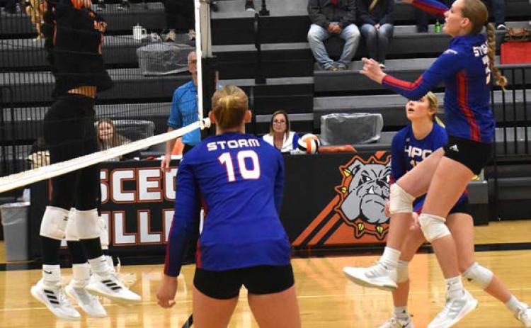 Rylee Hofmann gets a kill and tries to get it past Osceola’s block. PCN photo by Beth Sparrow.