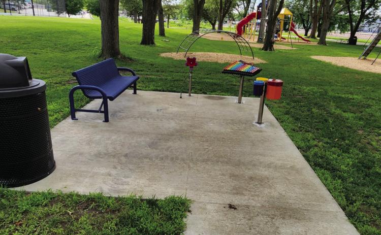 Top: The musical play area at the Osceola park is pictured. Below: A picnic table that is ADA compliant has been added to the shelter. PCN photos by Lexi Reimers.