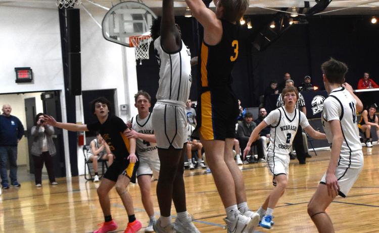 Dalton Pokorney tries to shoot over the Eagles’ tall guy. PCN photo by Beth Sparrow