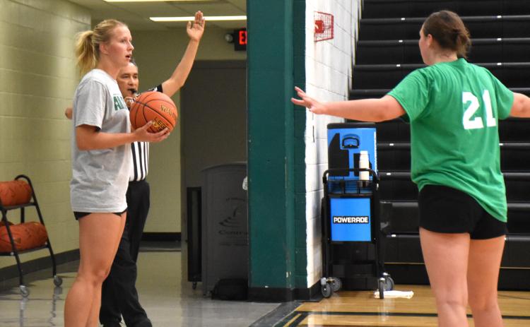 Lilly Peterson looks for an open team member past a team green defender. PCN photo by Beth Sparrow.