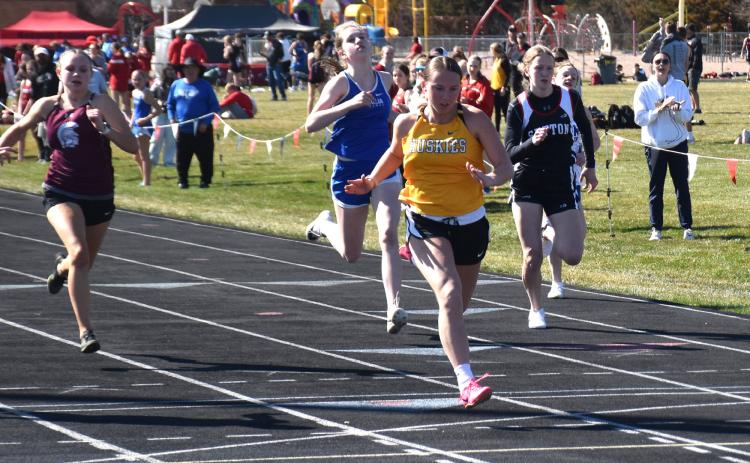 Kaylei Perry crosses the finish line first in the 100 meters. PCN photo by Beth Sparrow.