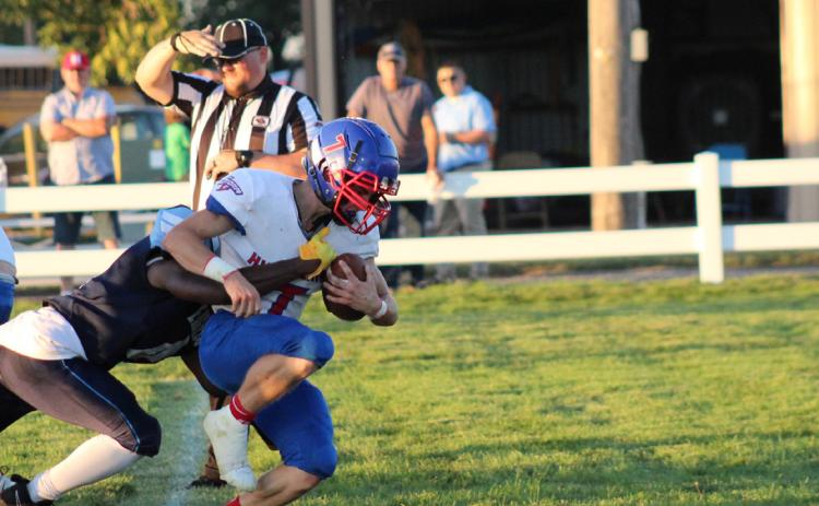 Haden Helgoth gets tackled by an Eagle defender. Photo by Stephanie Carlson, HPC yearbook.