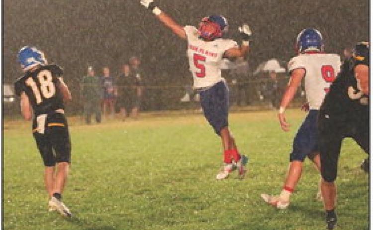 Raul Marino jumps for the ball in the rain Friday night against Nebraska Lutheran. PCN photo by Travis Lane.