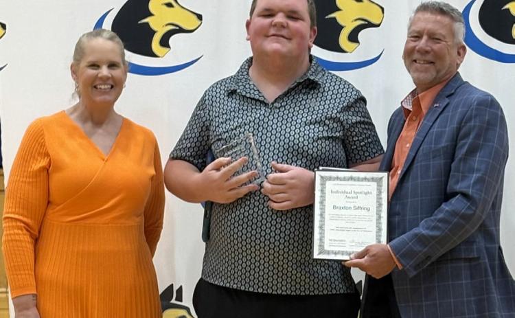 Braxton Siffring, senior at Shelby-Rising City was recently presented with the Spotlight Award. He is in the center, between presenters Jenn Clark and Tony Green of Nebraska DHHS. Photo provided.