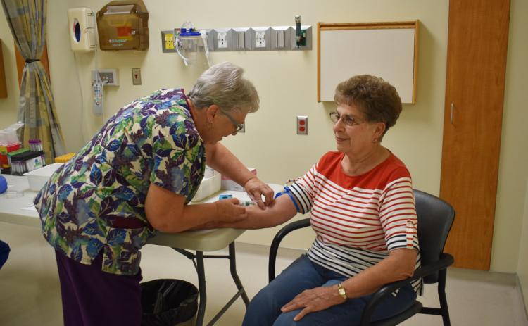 The Annie Jeffrey Health Fair was on Tuesday. Here lab tech Donna Hellbusch draws blood from participant Sheila Grossnicklaus. Photo by Beth Sparrow.