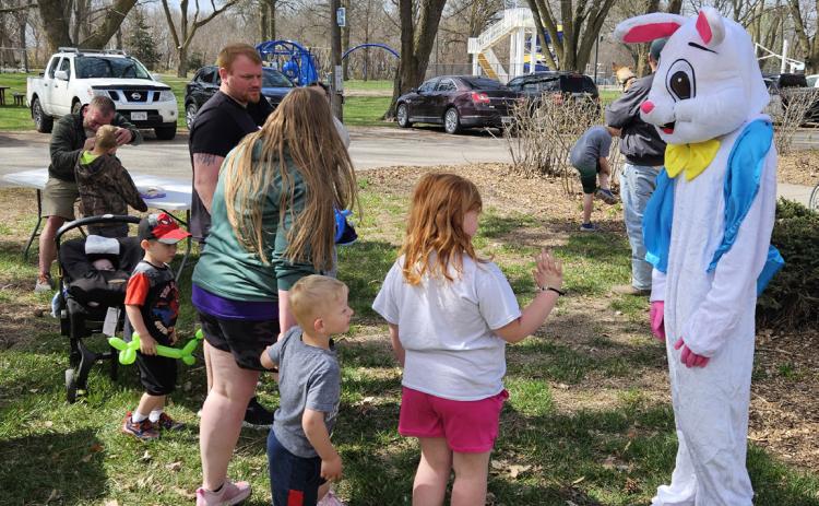 Above: Kids line up to visit the Easter bunny. Below: Kids wait for a balloon animal from Russ Hanson (formerly Rusty the Clown). Both taken at Stromsburg’s Easter egg hunt. Photos provided.