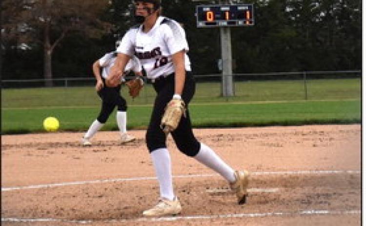 Above: Courtney Sunday pitches one at the game against Central City. Below: Adrienne Waller gets a hit. PCN photo by Beth Sparrow.