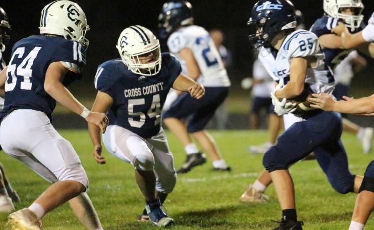 Devin Lonsdale (64) and Joaquin Alvarez-Rodriguez (54) converge on the GICC ball carrier in Friday night game at CC. PCN photo by Travis Lane.