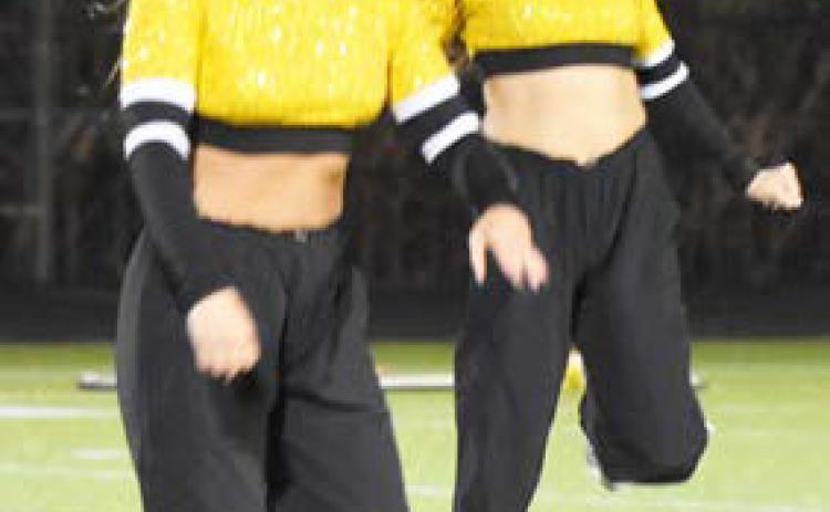 Left- Olivia Fredrick and Adelyn Favors dance during half time of the Neligh Oakdale at SRC football game. Charlie Thompson and Ashlyn Long perform on the field at halftime. PCN photos by Beth Sparrow.