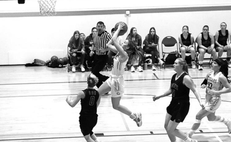 Lady Cougar Shyanne Anderson takes the ball in for a basket in the CRC tournament.