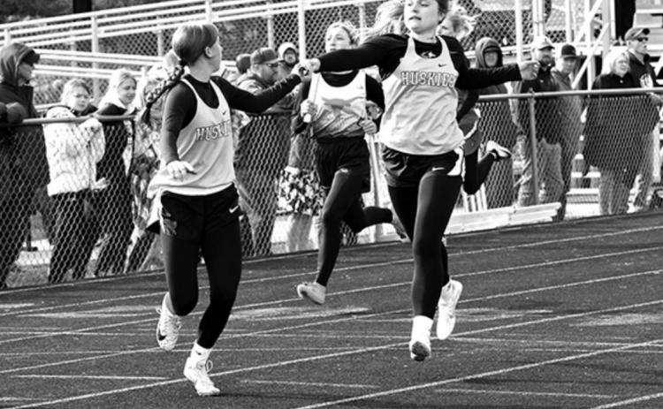 Shelby-Rising City’s winning 4 x 400 relay has Alex Larmon passing it off to Kaylei Perry.