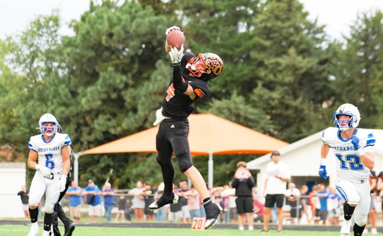 Osceola junior Landan Drozd climbs the ladder to snare this pass in the Bulldogs game with Archangels Catholic this past Friday night. Drozd had three receptions for 61 yards and led the defense with eight tackles. PCN photo by Blaine Winslow.