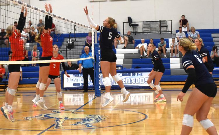 Above: Lilly Peterson (CC) spikes a kill past the red team’s blockers. PCN photo by Beth Sparrow.