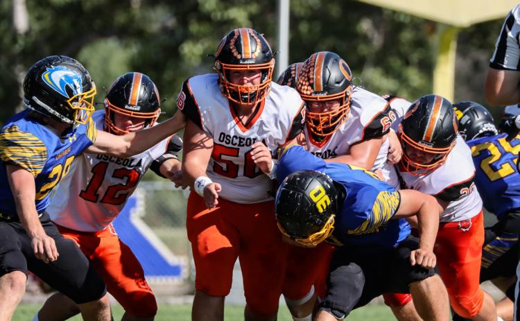 Liam White, Braylon Peterson, Brenden Gabel and Conner Schnell go for the tackle. PCN photo by Blaine Winslow.
