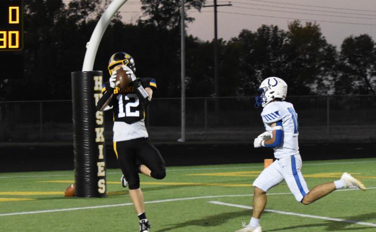 Shelby-RC junior Jett Vrbka (12) hauls in the pass from senior quarterback Logan Lindsley which was part of a 40-0 lead by the Huskies over the Centennial Broncos in the first quarter. PCN photo by Beth Sparrow.