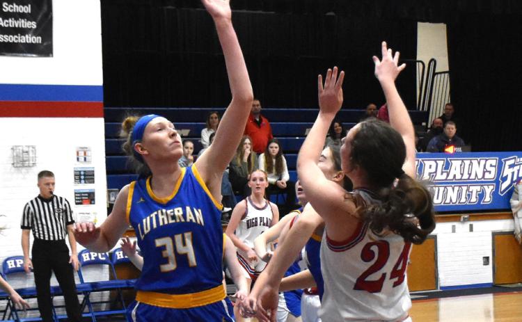 Rylee Ackerson shoots one over her taller opponent, Marissa Endorf of Neb. Lutheran. PCN photo by Beth Sparrow
