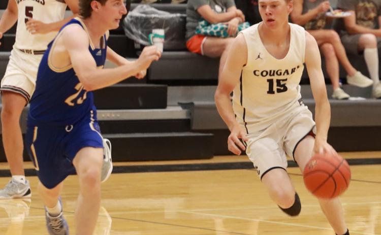Cross County’s Sawyer Anderson drives to the basket as Carter Molt of Riverside applies the defensive pressure. Anderson scored 18, all in the second half to lead the CRC to a 71-61 win over the GRC on Sunday. PCN photo by Ken Kush.