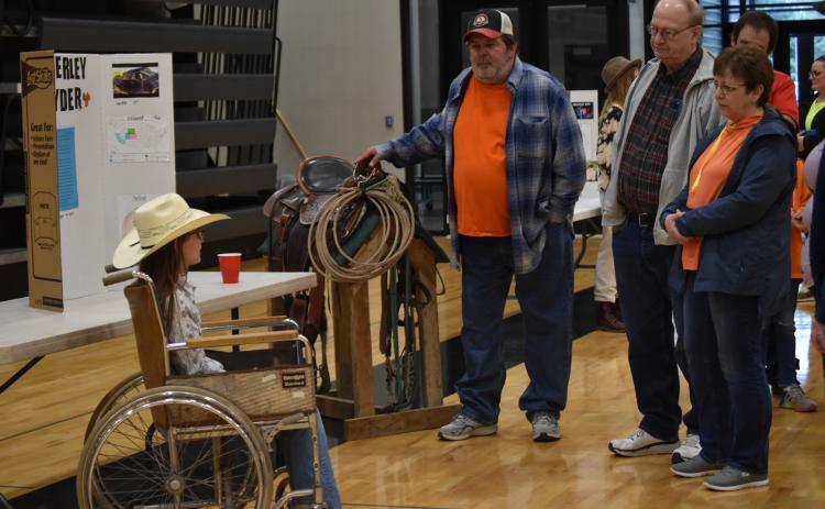 ABOVE: A group gathers to hear Emilia Pliefke portray professional barrel racer Amberley Snyder at the 5th Grade Wax Museum on Thursday, April 25.