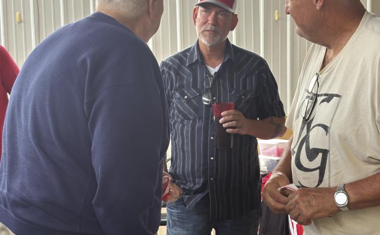 Dan Osborn talks to local people, Bob Waltman and Tim Alvis, on Friday at El Centenario in Stromsburg. PCN photo by Beth Sparrow.