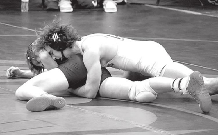 Grady Belt wrestles an opponent at David City last week. He won his weight class there. Photo by Jen Vrbka.