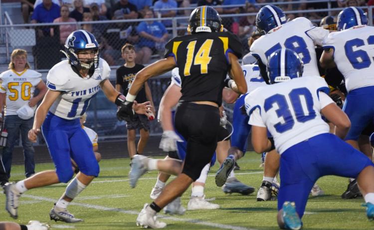 Landon Sliva tries to get away from a Titan defender. PCN photo by Jen Vrbka.