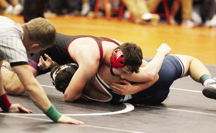 Top- High Plains Aaron Brown gets the pin on his way to the 165-pound title at Osceola.