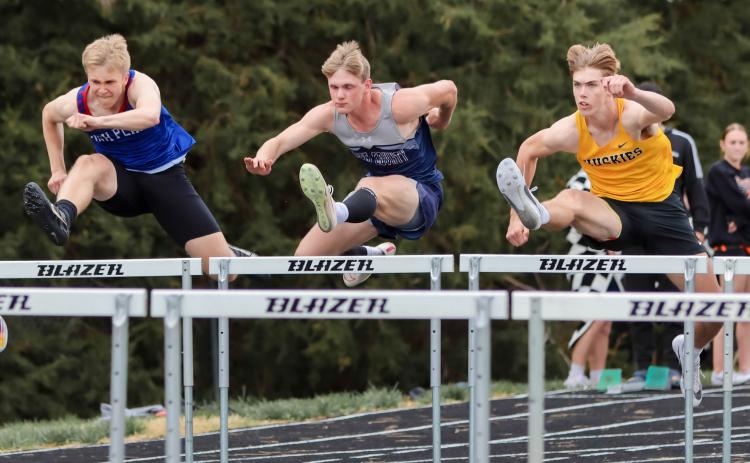 Above: Brodey Spurling (HPC), Cole Redden (CC) and Isaac Whitmore (SRC) leap over their hurdles. Whitmore took home gold. PCN photo by Blaine Winslow. Below: