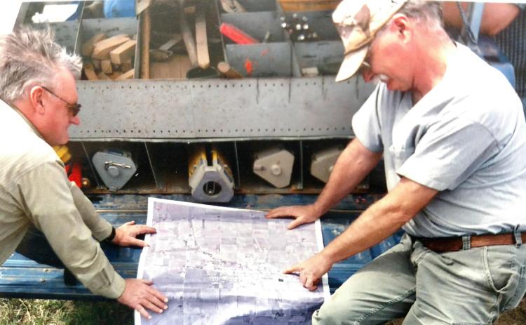 Above: Jay Bitner, NRD Engineer (left) and Jeff Ball (right) review the target locations to be surveyed for the aerial photogrammetry for Lincoln Creek around Aurora. Below right: Ball collects soils information for a watershed computer model. Photos provided by Upper Big Blue NRD.
