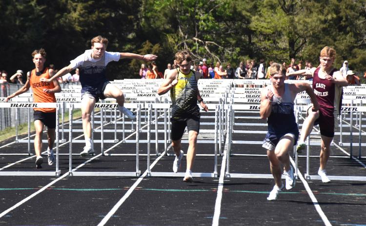 Kelby Neujahr approaches his hurdle (left), Colter Larson clears the hurdle and Cole Redden runs for the finish. PCN photo by Beth Sparrow.