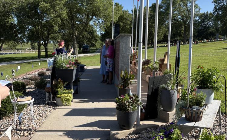 Above: The Osceola garden tour included a stop at the cemetery to see these beautiful flowers. Vicki Jones as “Rosie the Riveter” was on hand to stamp “passports” and help. Below: The garden at Good Sam Nursing Home was also on the tour. PCN photos by Beth Sparrow.