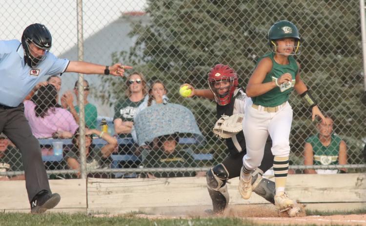 Polk County senior catcher Mady Berggren picks up the ground ball in front of home plate ands fires on to first base. In two games this week Berggren was 5 for 6 with two home runs, a triple and six RBI’s. PCN photo by Ken Kush.