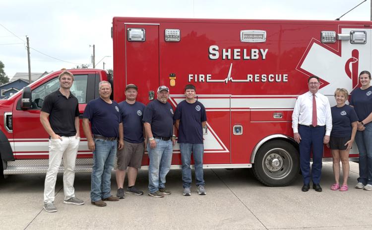 Above: Mike Flood (in white shirt) visited the Shelby Fire District on Thursday. Below: Fire chief Jon Eller tells Flood about some of the equipment and how much it costs. PCN photos by Beth Sparrow.