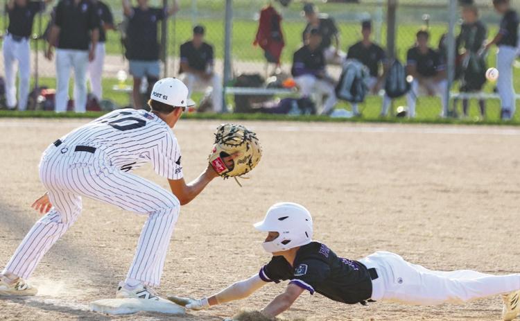 Easton Cattau dives back into first base on the attempted pick-off throw by the Albion pitcher during last Thursday night;s game. PCN photo by Blaine Winslow.