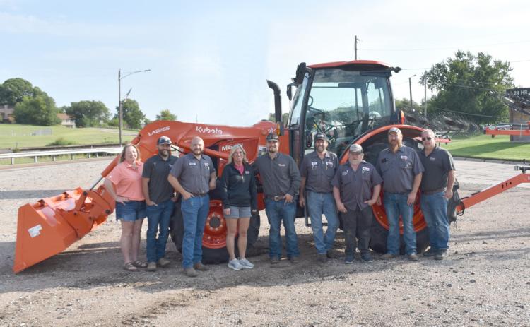 Osceola Implement was recently named a Kubota Dealer of Excellence. Employees and owners are pictured here in front of a Kubota tractor. PCN photo by Beth Sparrow.