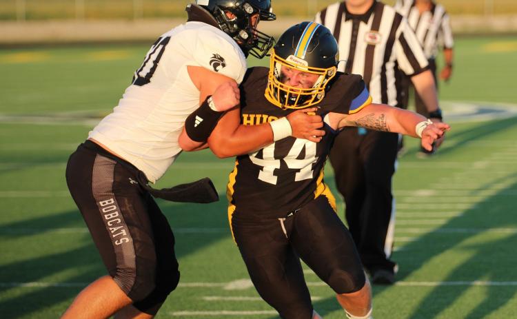 Shelby-RC senior Eli Fjell (44() tries to fight through the block of an Exeter-Milligan/Friend offensive lineman in Friday night’s game at Shelby. SRC improved to 3-0 with a 46-10 win over the Bobcats. PCN photo by Travis Lane.