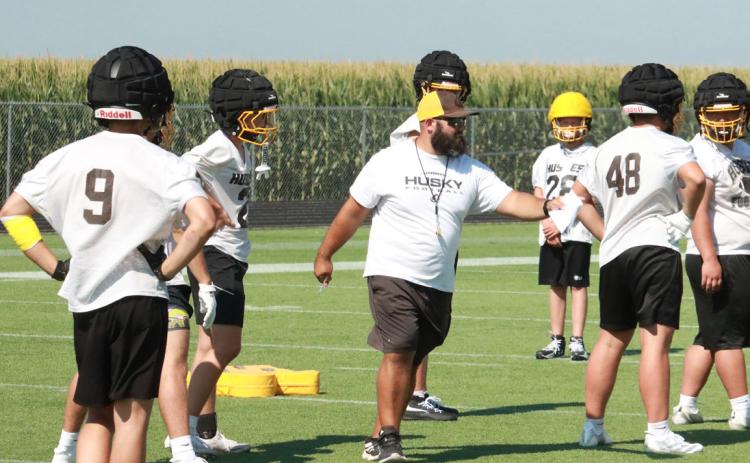 Shelby-RC head football coach Zach Kubik helps to get players in the right positions during the Huskies summer team camp last week. PCN photo by Ken Kush.