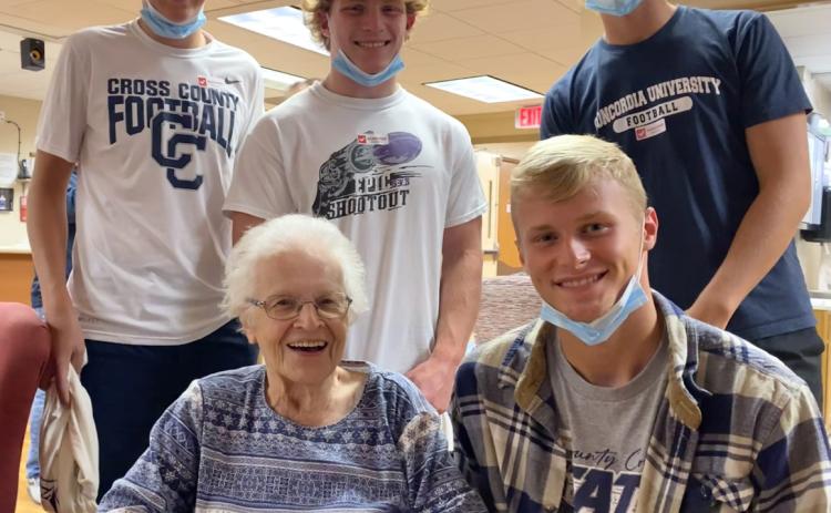 (left to right) Ashton Seim, Lottie Johnson, Izaac Dickey, Jackson Lindburg and Tanner Hollinger Lottie Johnson was visited by Cross County athletes (which included her great-grandson Jackson) and presented with a Cougar t-shirt as the MCH Fan of the Week. T-shirt provided by Cross County Booster Club.Photo provided by Erin Dickey.