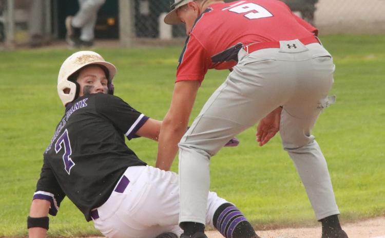 SOS’s Ruger Webb looks back as the ball gets away from the Hebron third baseman and Webb scores the first run of the game on Friday in the Rebels 7-1 win. PCN photo by Ken Kush.